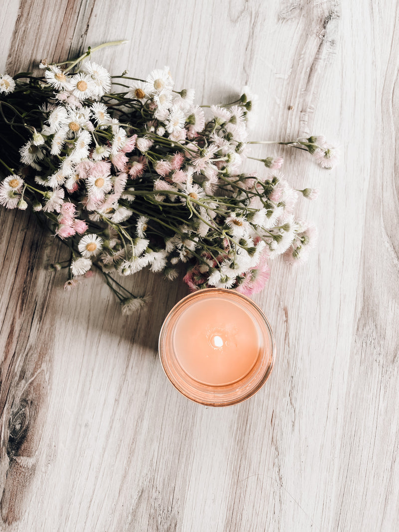 A lot Soy candle with a subtle and sweet glow for cozy farmhouse decor. Paired with fresh flowers